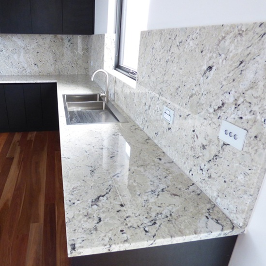 una cocina con encimeras de Granito Delicatus